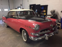 red antique car in garage